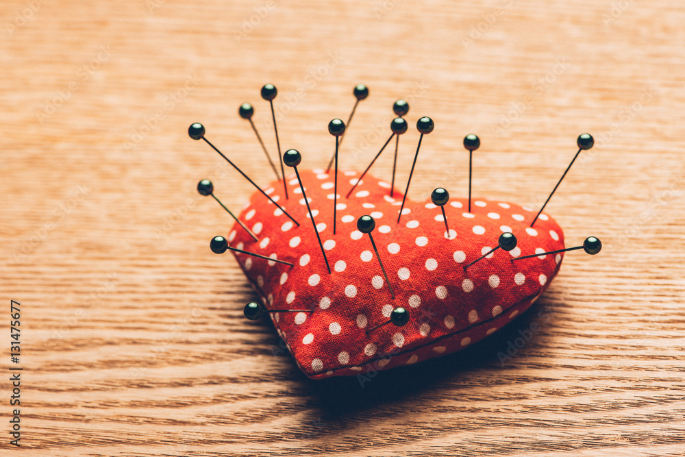 Vintage heart and needles on wooden desk. Valentines day concept