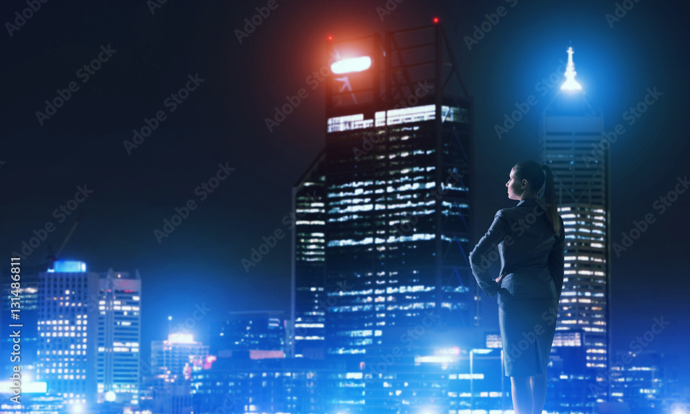 Woman looking at night city