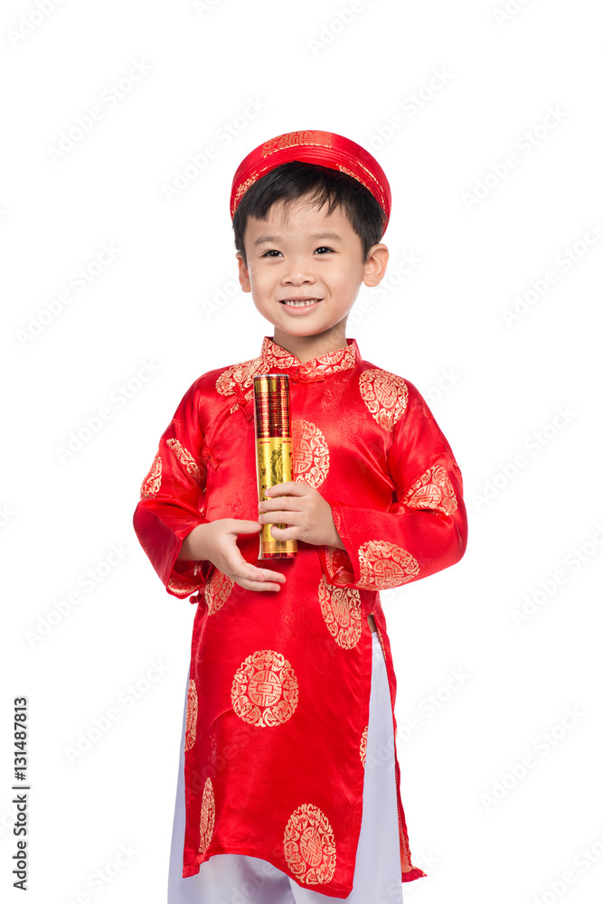 Happy Vietnamese boy in red Ao Dai celebrating New Year with con