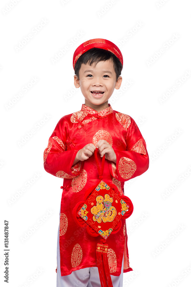 Vietnamese boy cuddling stuffed carp. Portrait of a handsome Asi