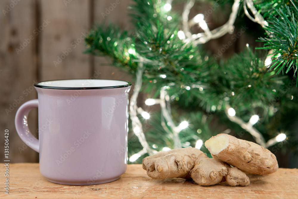 Ginger tea in a cup on wooden background