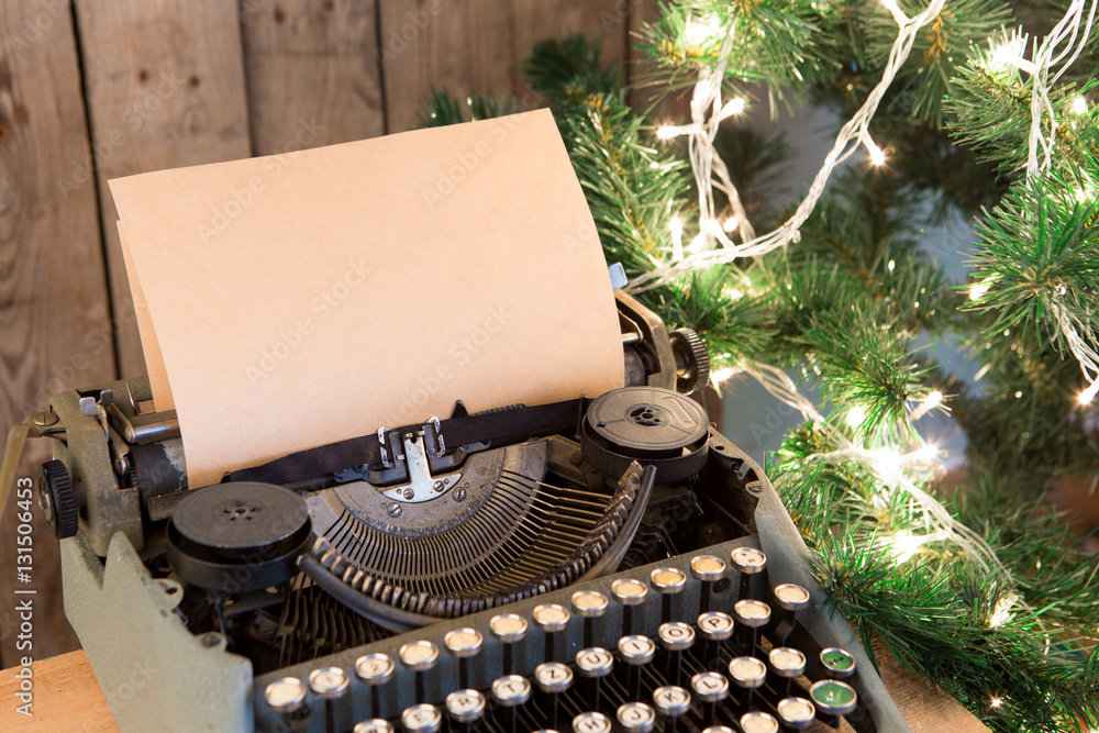 Christmas concept - Typewriter with the blank paper and lights