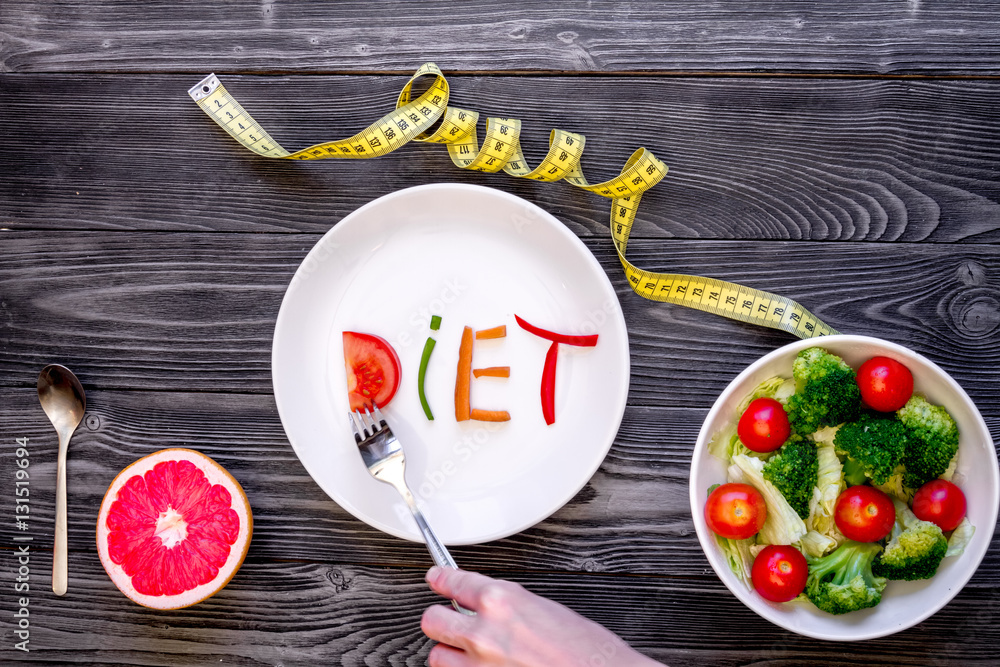 concept slimming diet fresh vegetables on wooden background top view