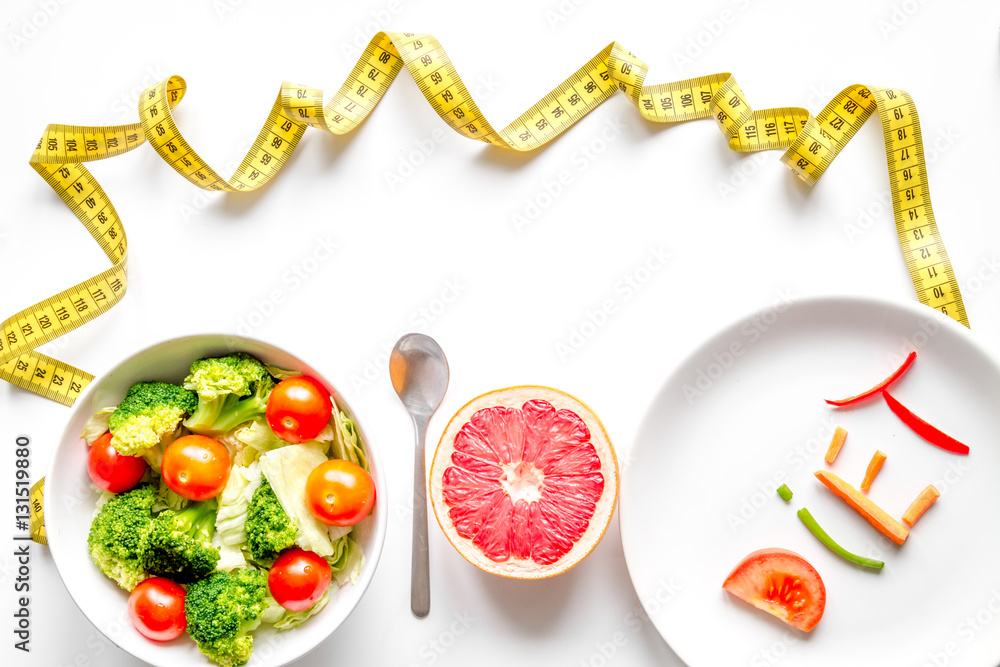 concept slimming diet fresh vegetables on white background top view