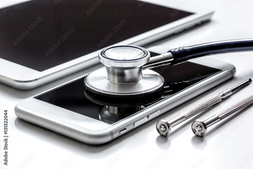 diagnostic of gadgets on white background with stethoscope