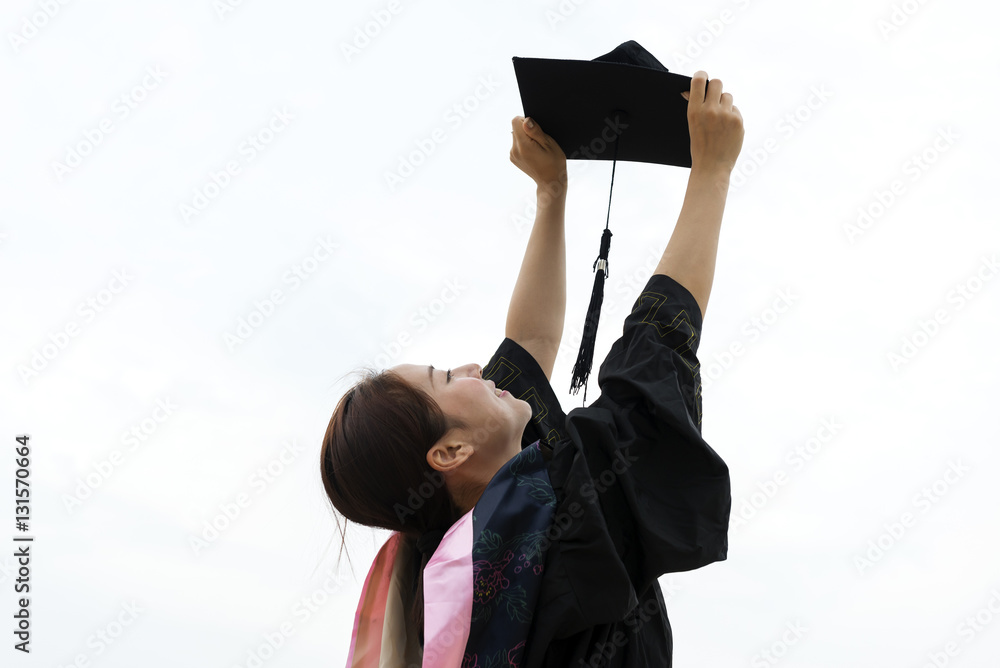 Beautiful female graduate wearing graduation gown