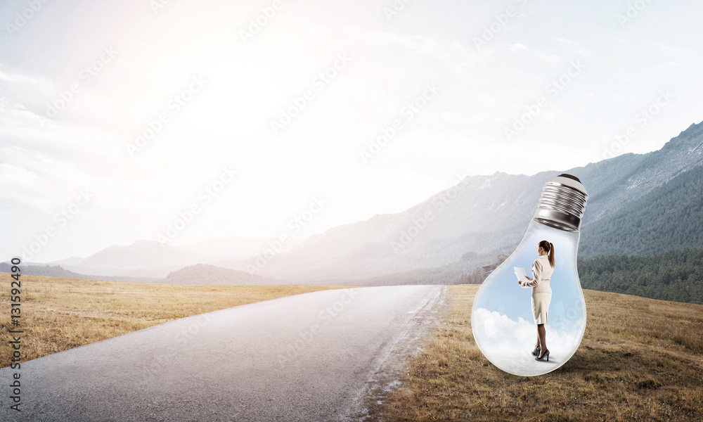 Businesswoman inside light bulb