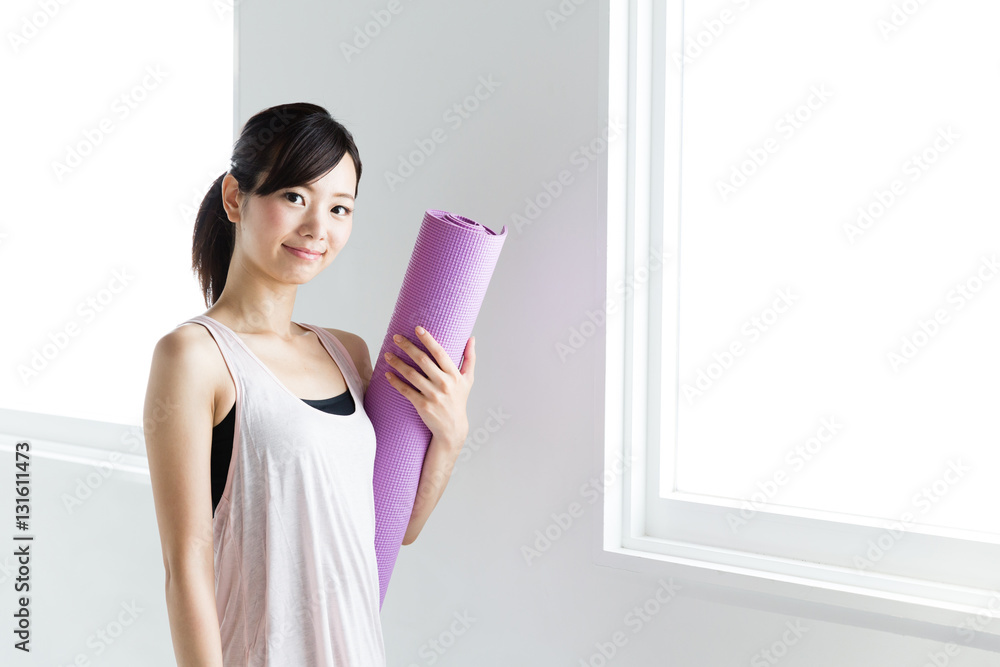 young asian woman relaxing in sports gym