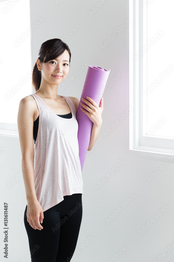 young asian woman relaxing in sports gym