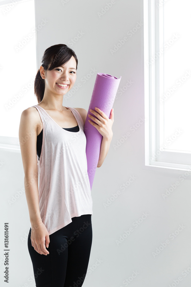 young asian woman relaxing in sports gym