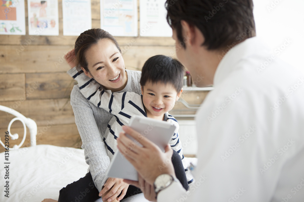 The doctor explains it while showing the tablet to parent and child