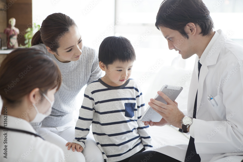 The doctor explains it while showing the tablet to parent and child