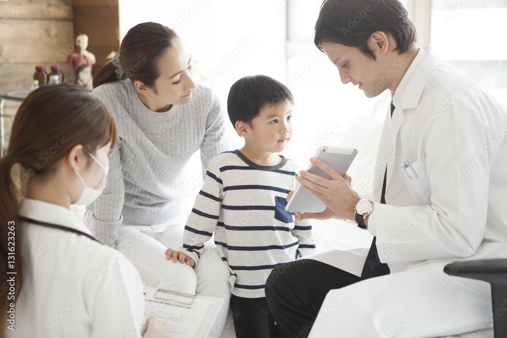 The doctor explains it while showing the tablet to parent and child