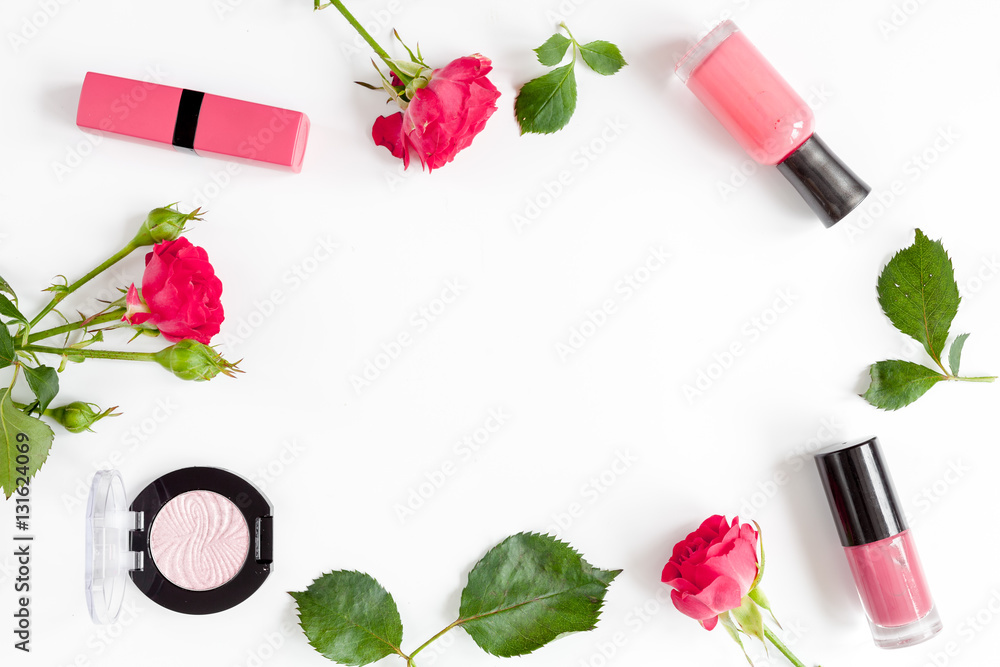 berry color decorative cosmetics with roses white background top view