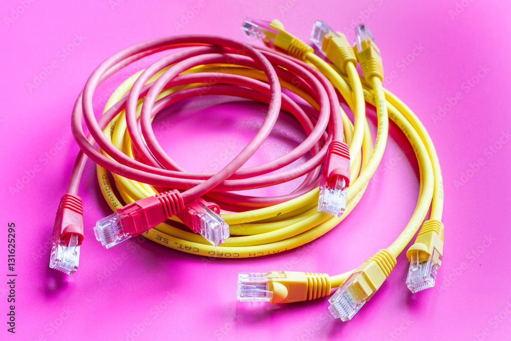 concept network internet cable on pink background close up