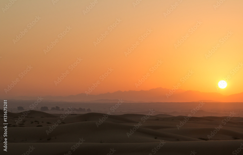 Hot sunrise in the desert dunes of Dubai, United Arab Emirates.