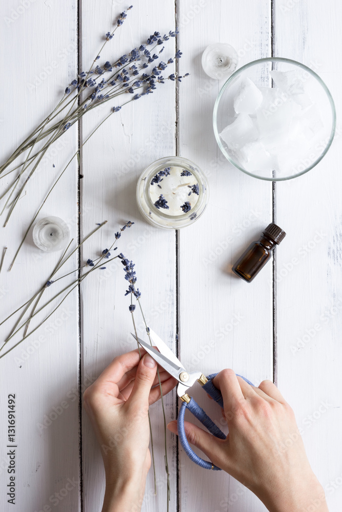 handmade candles with lavender on wooden background top view