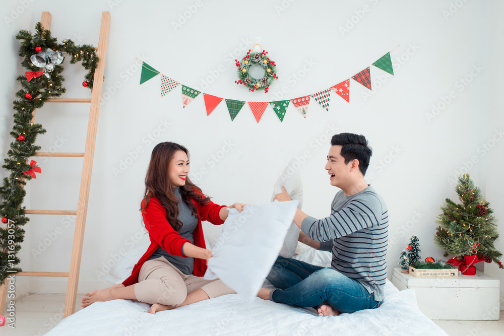 Christmas Asian Couple.Happy Smiling Family at home celebrating.