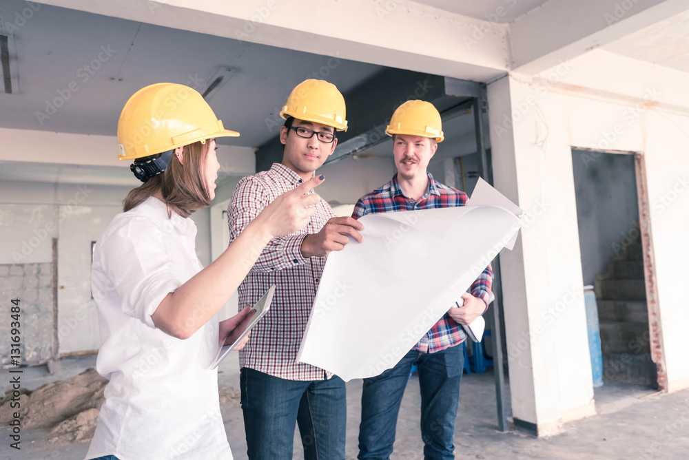 three construction engineers working together in side buiding pl