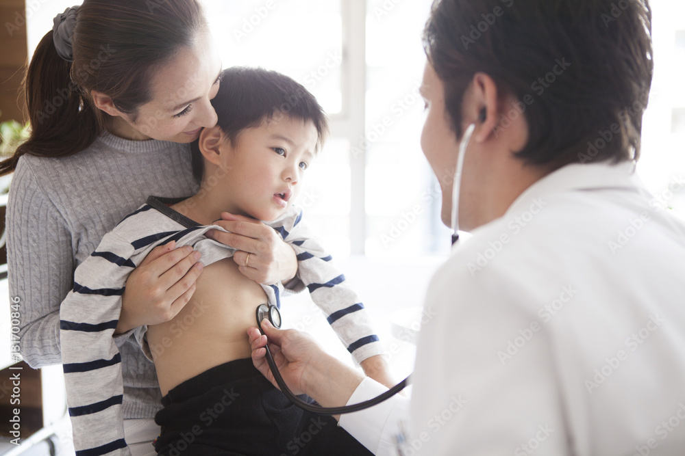 The boy is undergoing a screening in the pediatric department