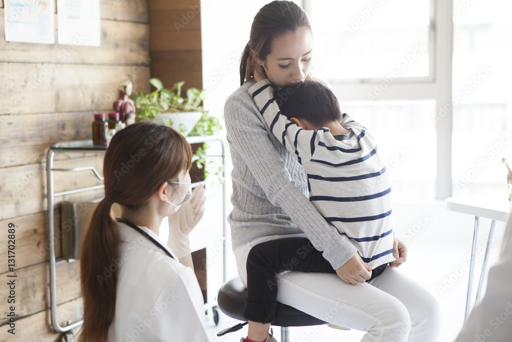 The woman is visiting the hospital with her young son