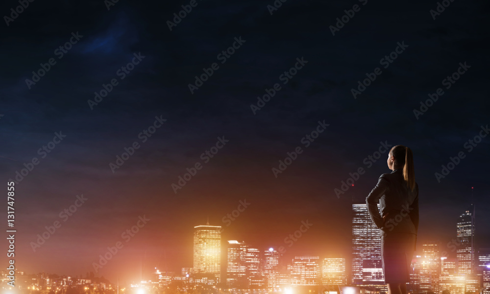 Woman looking at night city