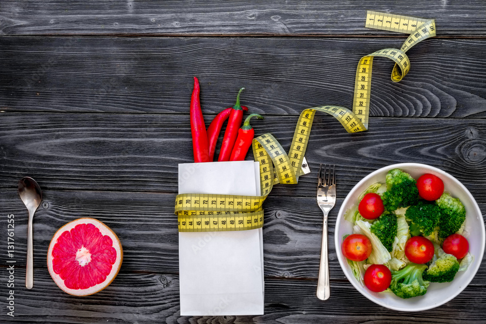 concept slimming diet fresh vegetables on wooden background top view