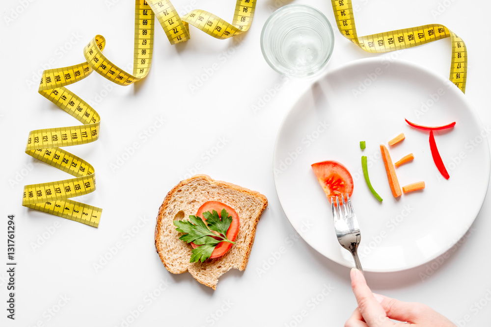 concept slimming diet fresh vegetables on white background top view