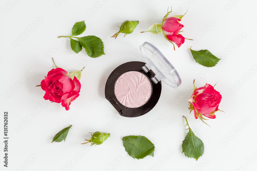 berry color decorative cosmetics with roses white background top view