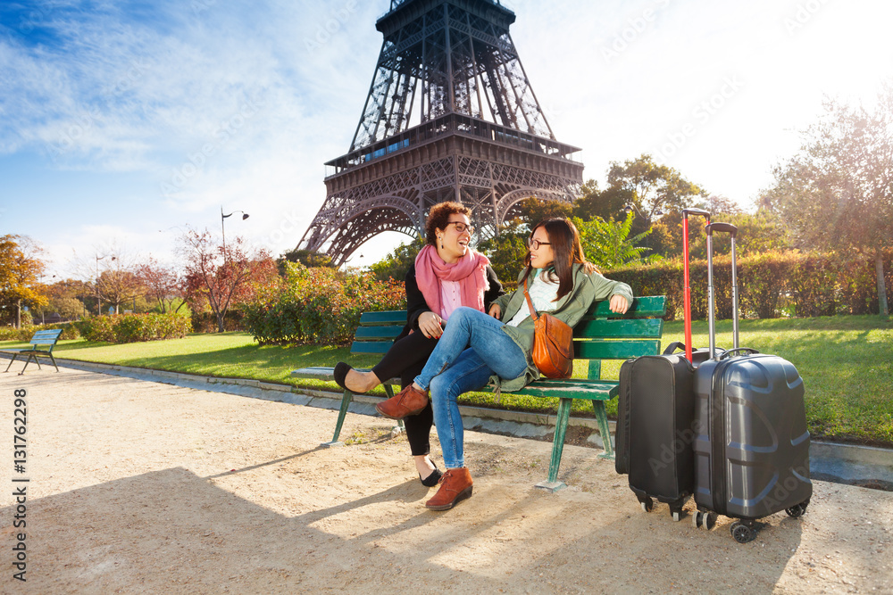 Friends talking to each other near Eiffel Tower