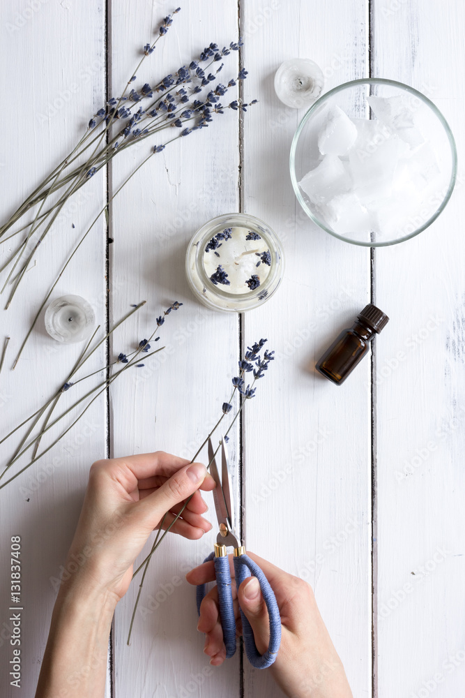 handmade candles with lavender on wooden background top view