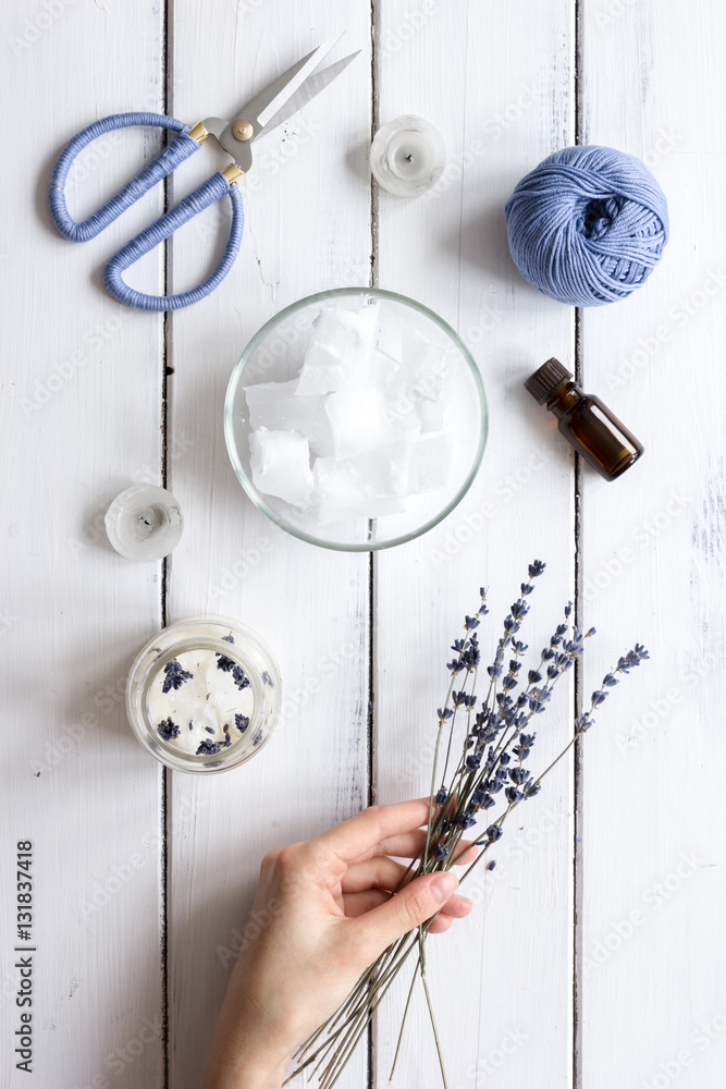 handmade candles with lavender on wooden background top view