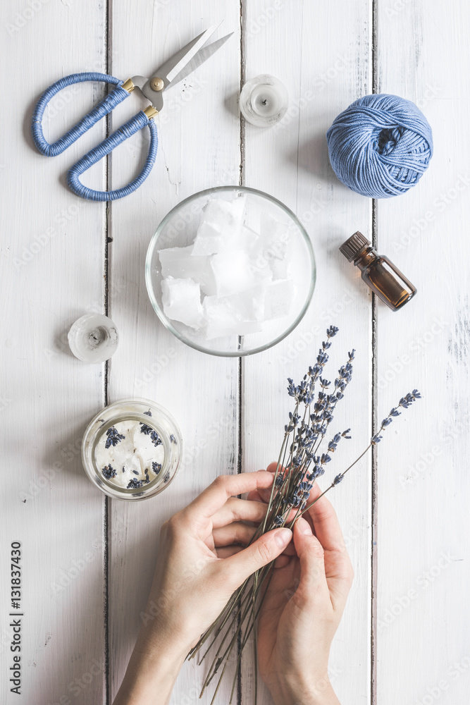 handmade candles with lavender on wooden background top view