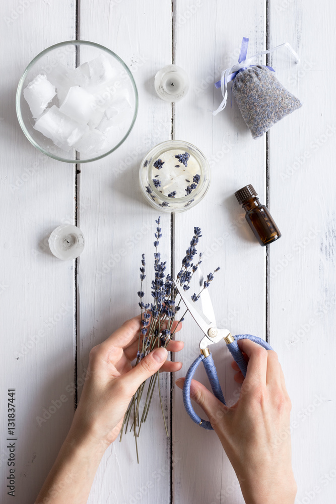 handmade candles with lavender on wooden background top view