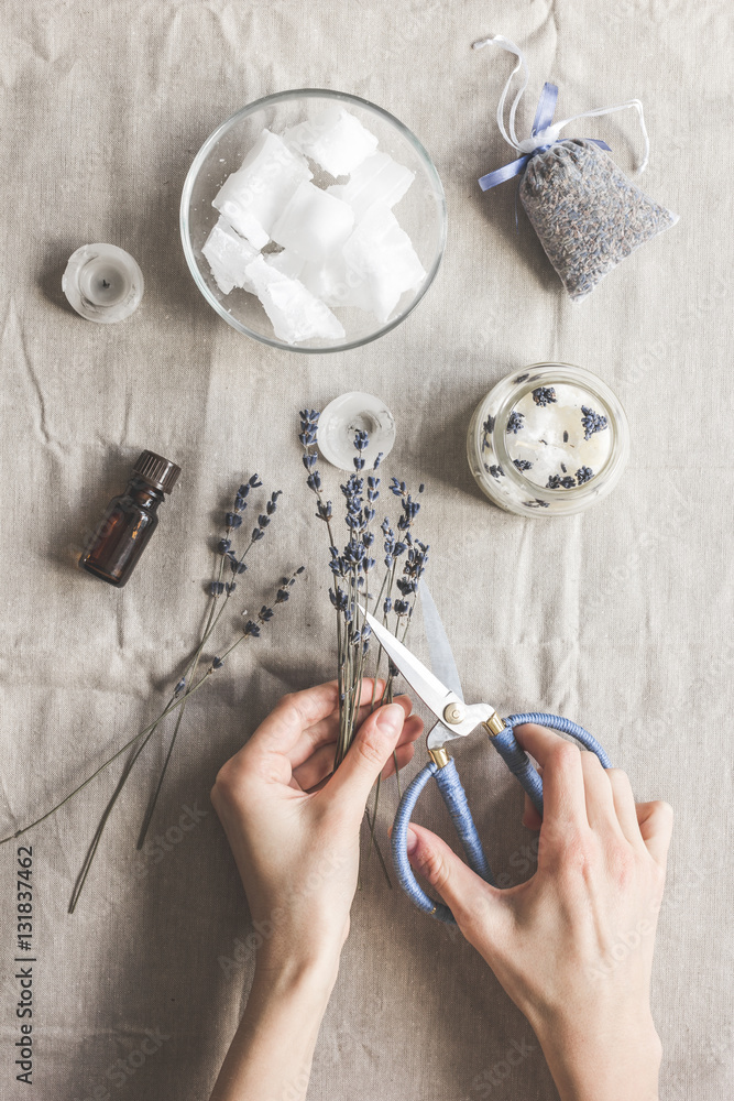 handmade candles with lavender on textile background top view