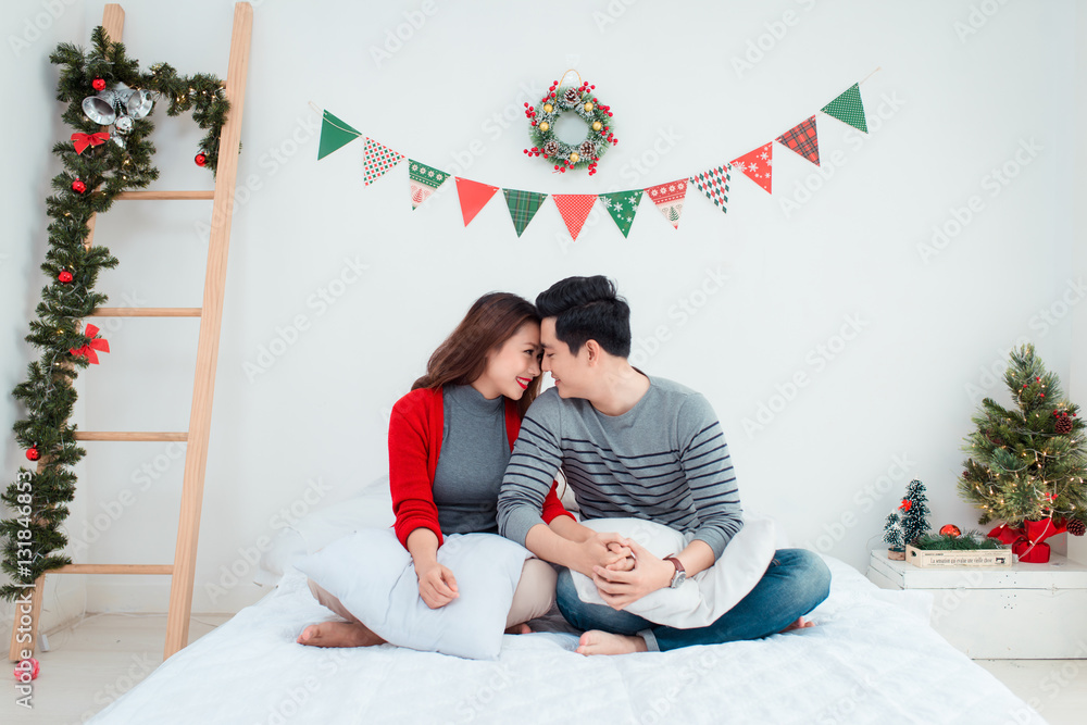 Christmas Asian Couple.Happy Smiling Family at home celebrating.