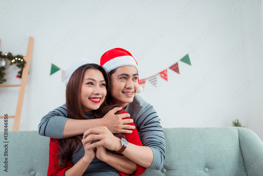 Christmas Asian Couple.Happy Smiling Family at home celebrating.