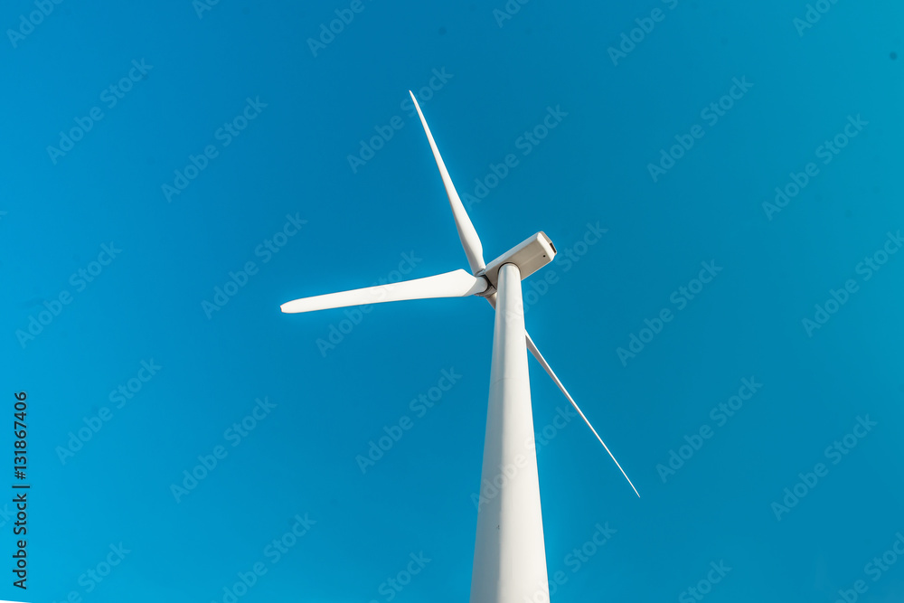 Wind turbines. Ecology wind against cloudy sky background with c