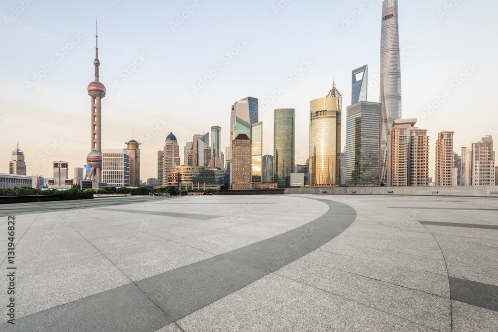 Empty floor with modern skyline and buildings at dusk in Shanghai