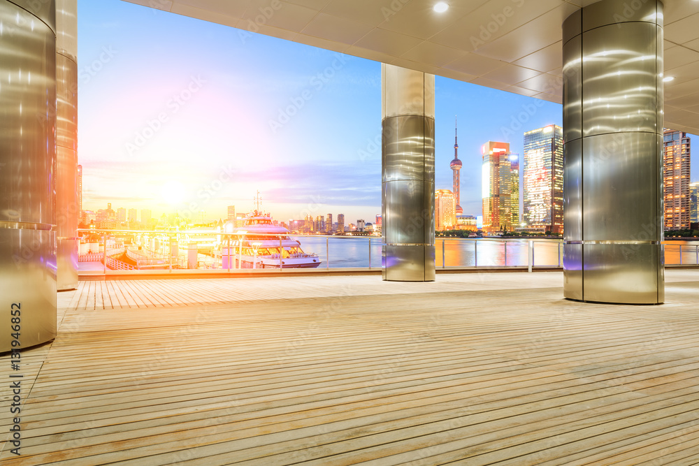 Empty floor with modern skyline and buildings at sunset in Shanghai