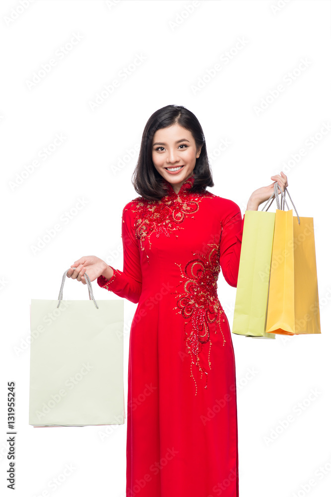 Vietnamese beautiful woman holding shopping bags isolated on whi