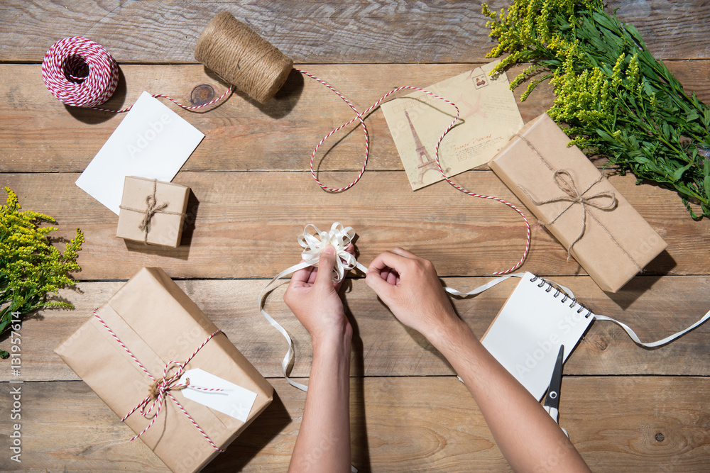 Preparing gift over wooden background. View from above