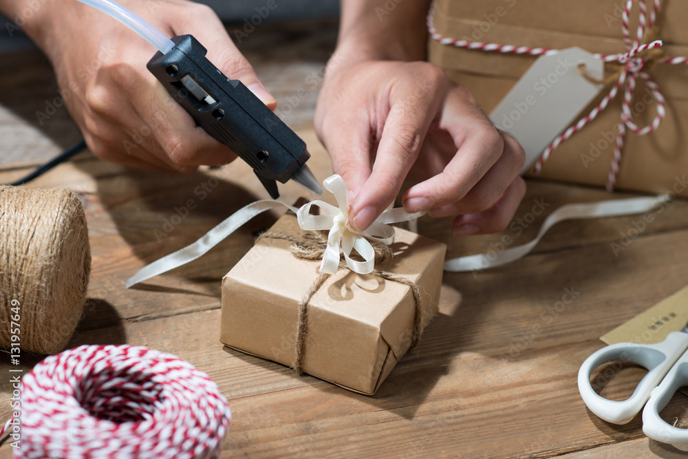 Christmas decorated gift box over wooden background. View from a