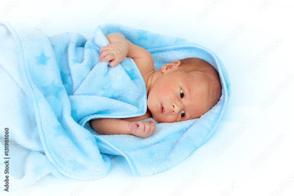 One week old baby in blanket on white background