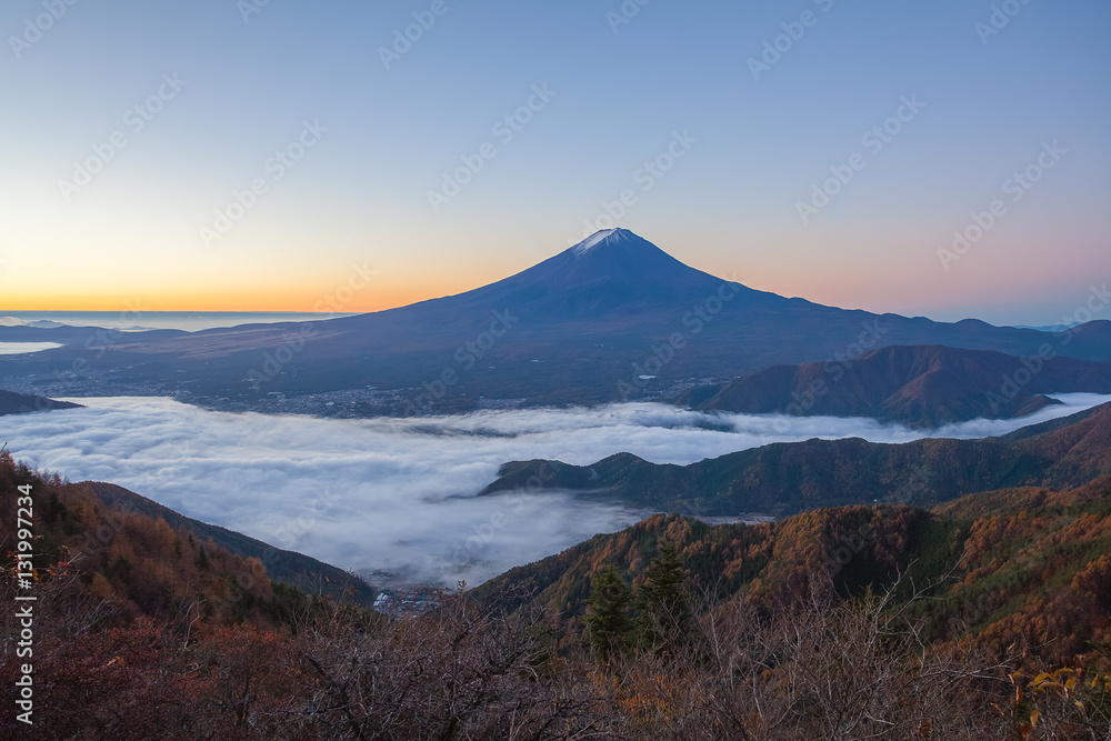 Mountain Fuji and sea of mist above Kawaguchiko lake in morning autumn season