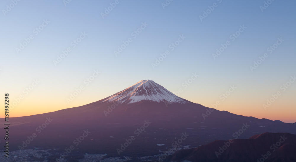 Top of Mt. Fuji and sunrise sky in autumn season