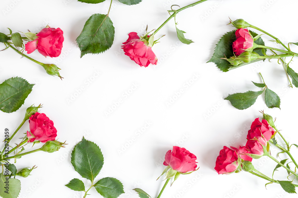 berry color decorative cosmetics with roses white background top view