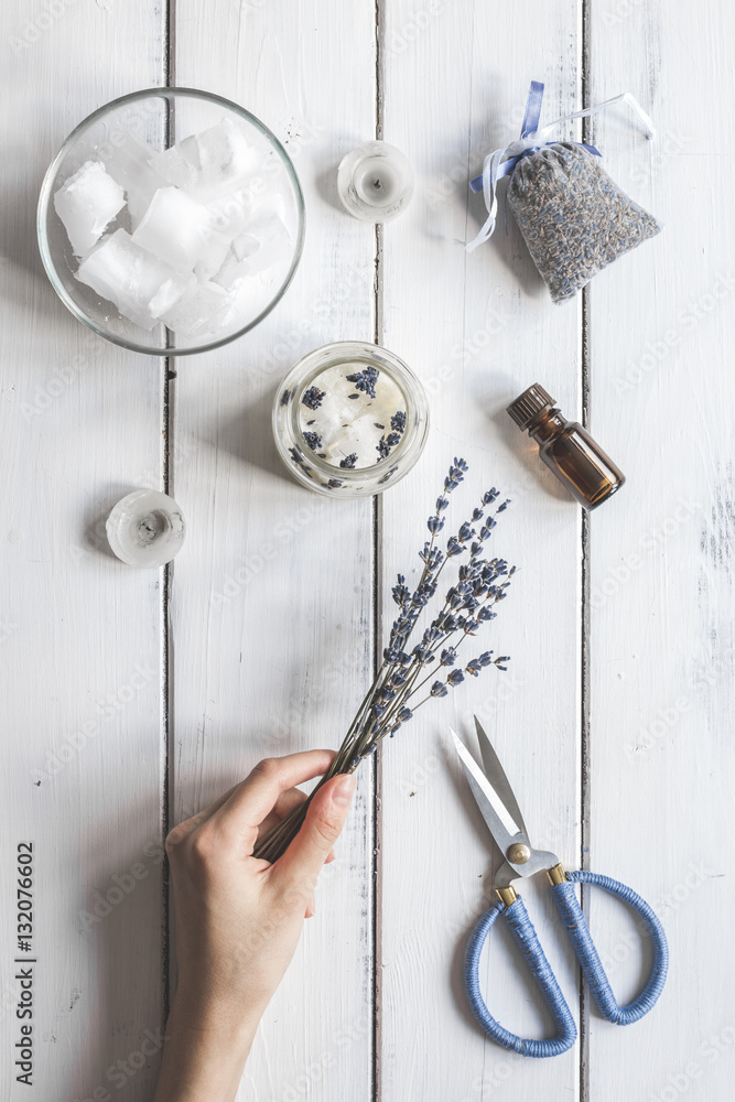 handmade candles with lavender on wooden background top view