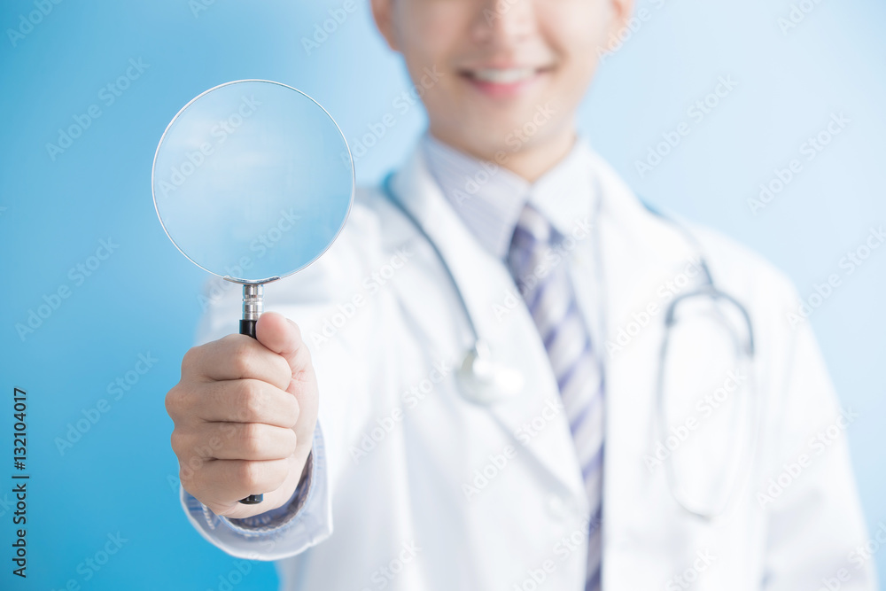 male doctor take magnifier