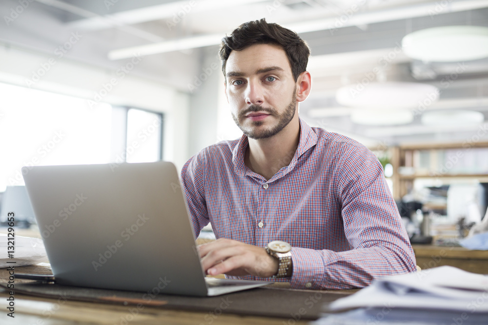 Male architect working with laptop in the office